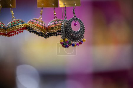 Photo for Traditional ethnic colorful earnings jewellery over blur background and copy space. Selective focus. - Royalty Free Image