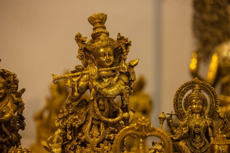 Brass metal art, Handmade Indian god Krishna sculpture souvenir made with brass with blur background. Selective focus.