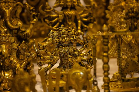 Brass metal art, Handmade Indian Lord Hanuman sculpture souvenir made with brass with plain background. Selective focus.