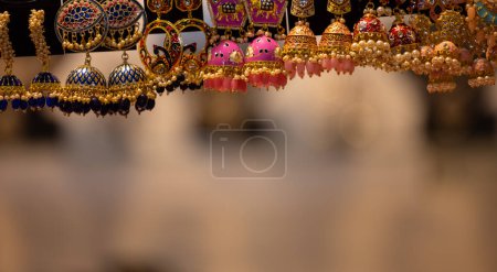 Traditional ethnic colorful earnings jewellery over blur background and copy space. Selective focus.