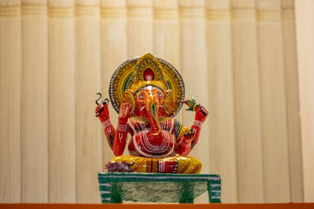 Wooden art, handmade colourful Lord Ganesh souvenir made with wood in display to worship.