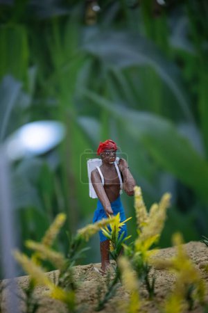 Photo for Handmade idol of indian farmer while working in farming field made with clay. Selective focus. - Royalty Free Image