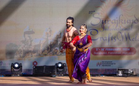 Téléchargez les photos : Faridabad, Haryana, Inde - 17 février 2024 : Portrait de l'artiste sud-indienne masculine et féminine exécutant des kuchipudi de danse classique sur scène à la foire artisanale de surajkund. - en image libre de droit