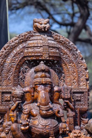 Photo for A handmade wooden idol of Lord Ganesh sounds like a beautiful tribute to the deity's revered presence in Hindu mythology and culture. - Royalty Free Image
