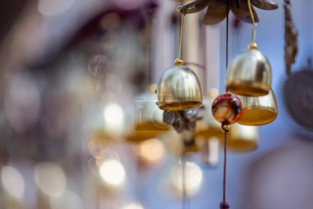 Photo for Hanging wind bells on shop with blur background at fair. - Royalty Free Image