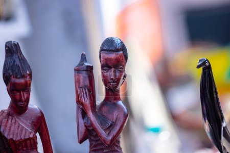 Foto de Handmade tribal people of africa souvenir idol from african artist on display at surajkund craft fair for sale. Selective focus. - Imagen libre de derechos