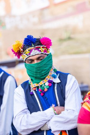 Foto de Faridabad, Haryana, India - February 17 2024: Portrait of an male artists from gujrat state in ethnic traditional dress participating in surajkund crafts fair to perform their cultural folk dance. - Imagen libre de derechos