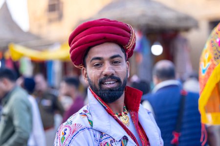Photo for Faridabad, Haryana, India - February 17 2024: Portrait of an male artists from gujrat state in ethnic traditional dress participating in surajkund crafts fair to perform their cultural folk dance. - Royalty Free Image