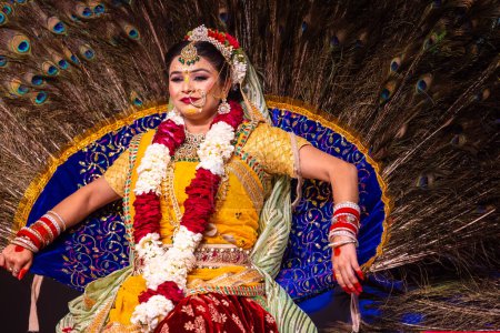 Foto de Ghaziabad, Uttar Pradesh, India - 17 de marzo de 2024: Retrato de una joven artista actuando como diosa radha durante el festival holi milan con coloridas ropas étnicas y joyas. - Imagen libre de derechos