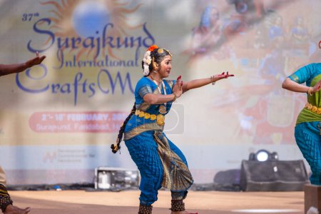 Photo for Faridabad, Haryana, India - February 17 2024: Female south indian artists performing classical dance kuchipudi at surajkund craft fair in traditional silk sarees and jewelry. - Royalty Free Image