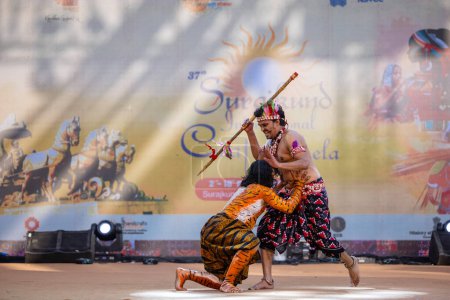 Téléchargez les photos : Faridabad, Haryana, Inde - 17 février 2024 : Portrait d'artistes du sud de l'Inde exécutant des kuchipudi de danse classique comme chasseur et tigre sur scène en vêtements ethniques lors de la foire artisanale surajkund. - en image libre de droit