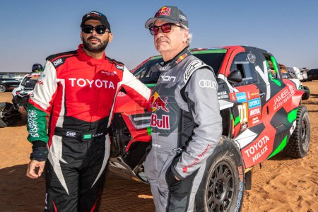 Photo for Yanbu, Saudi Arabia. 05-19 Jenuary 2024. 46 Rally Dakar. #201, Yazeed Al-Rajhi, Toyota, talking with Carlos Sainz, Audi, at stage start. - Royalty Free Image