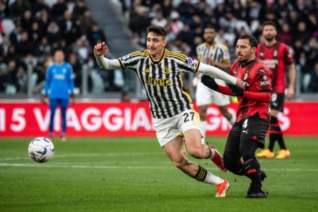 Photo for Turin, Italy. 27 April 2024. Italian Serie A Football Championship. Juventus FC vs AC Milan 0-0. Andrea Cambiaso, Juventus, and Ismael Bennacer, Milan, vie for the ball. - Royalty Free Image