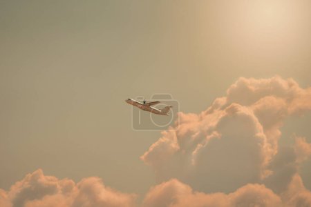 small plane rising through the clouds