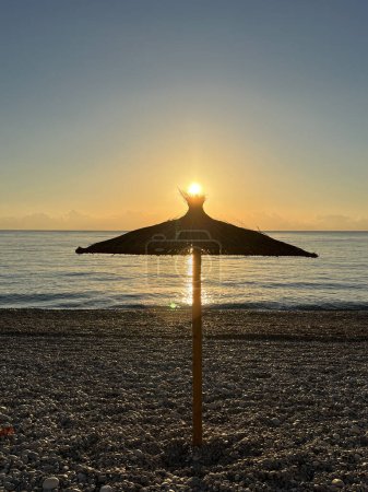 Photo for Parasol with sunrise on the beach in Albir Spain - Royalty Free Image