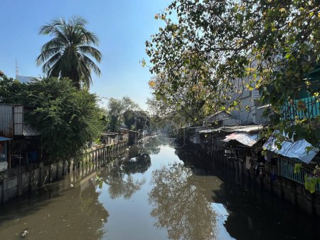 Canal and houses in Khlong Hua Lamphong in Bangkok, Thailand