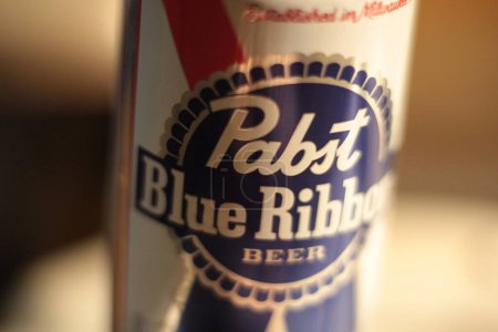 Photo for New York, NY - March 17, 2021: Close up of Pabst Blue Ribbon Beer label with shallow depth of field focus blur and bokeh background in warm light - Royalty Free Image