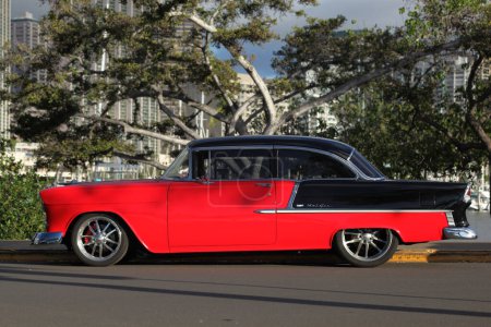 Photo for Right side profile of beautifully restored red and black classic 1950s Chevy Belair 2 automobile - Royalty Free Image