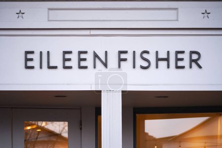 Foto de Connecticut, Estados Unidos - 7 de abril de 2023: Eileen Fisher boutique store in commercial shopping district logo sign closeup. - Imagen libre de derechos