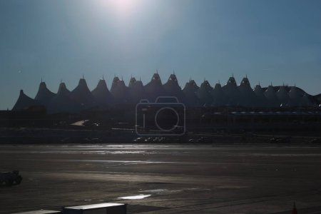 Foto de Denver, CO - 18 de diciembre de 2022: Línea de silueta del Aeropuerto Internacional de Denver Jeppesen Terminal contra el cielo azul de la mañana - Imagen libre de derechos