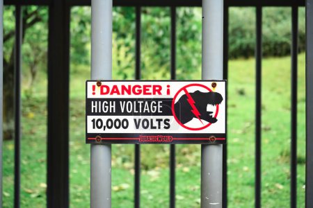 Photo for Kaneohe, HI - Jan. 10, 2024 : Danger! High voltage 10,000 volts electrified fence tyrannosaurus dinosaur cage warning sign movie prop from Jurassic World film - Royalty Free Image