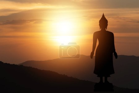 Photo for Silhouette big buddha statue sun shining from behind mountain sky sunset background.Makha Bucha Day, Vesak Day, Asanha Bucha, Buddhist Lent. Religion buddha concept. - Royalty Free Image