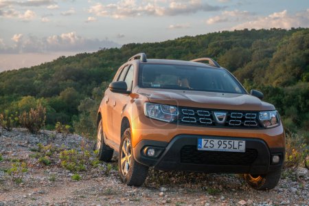 Photo for Dacia Duster SUV at a vantage point during a beautiful sunrise - Royalty Free Image