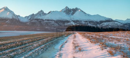 Photo for Farm fields in Slovakia in winter scenery with the Tatras in the background - Royalty Free Image