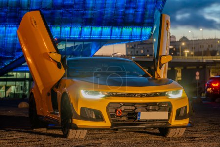 Photo for Chevrolet Camaro ZL1 with gullwing doors.Presentation against a background of beautiful illuminations - Royalty Free Image
