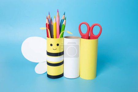 Photo for Homemade pencil holder, toilet paper roll craft concept for kid and kindergarten, DIY, tutorial,bee toy, blue background - Royalty Free Image