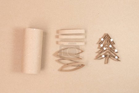 Photo for A paper Christmas tree made out of toilet paper rolls, recycled concept, DIY, tutorial, educational art for kids, top view - Royalty Free Image