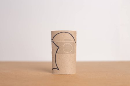 Photo for DIY ideas for paper craft for kids, process of making mouse from empty recycled toilet paper roll, a piece of cardboard sitting on top of a table, close-up photo - Royalty Free Image