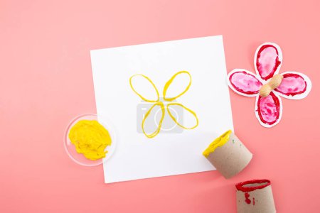 Photo for Part of process making paper craft butterflies, stamp, paint tubes, recycling concept, easy craft for kids, DIY, tutorial - Royalty Free Image