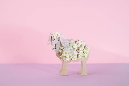 Embrace the spring spirit with this charming folk art photo featuring a sheep crafted from a toilet paper roll. Adorned with vibrant flowers, it adds a delightful touch to your seasonal decor