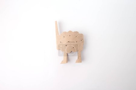 a carton body blank, a cutout used for crafting, placed on a white surface. It showcases a folk art style and is part of a crafting process. sheep project, simple spring activity for kids, tutorial, 