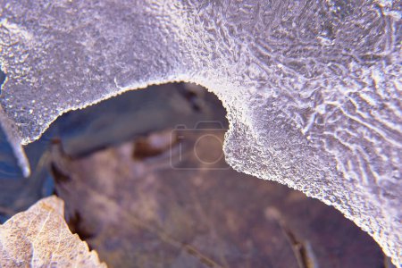 Detail of ice blocks, over mountain stream. blurred background, macro photography, water, winter, cold, ice texture zenithal view