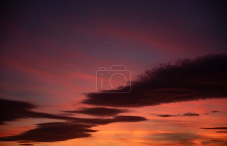 Mesmerizing Sunset Sky: A Symphony of Colors.Witness a mesmerizing sunset sky, orchestrating a symphony of colors with vibrant clouds in hues of orange, yellow, and magenta, creating an enchanting and