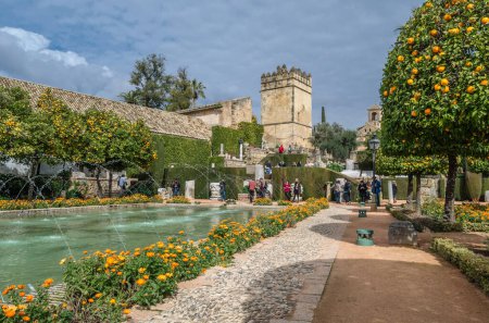 Photo for CORDOBA, SPAIN - FEBRUARY 16, 2014: People visiting the beautiful gardens of the Alcazar de los Reyes Cristianos (Spanish for "Castle of the Christian Monarchs"), a medieval fortress located in the historic center of Cordoba, Andalusia, southern Spa - Royalty Free Image