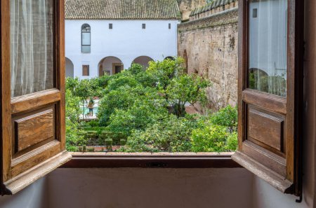 Photo for CORDOBA, SPAIN - FEBRUARY 16, 2014: View of The courtyard of the Moriscos (also known as the Mudejar Courtyard) located inside the Alcazar de los Reyes Cristianos, a medieval fortress in Cordoba, Andalusia, southern Spain - Royalty Free Image