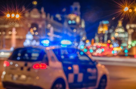 Photo for Out of focus view of a police car with sirens on, at night - Royalty Free Image