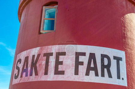 Architectural detail of the lighthouse in the town of Alesund, More og Romsdal County, Norway. The inscription "Sakte fart" on the wall means "Slow speed"
