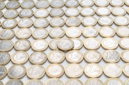Several one euro coins on white background