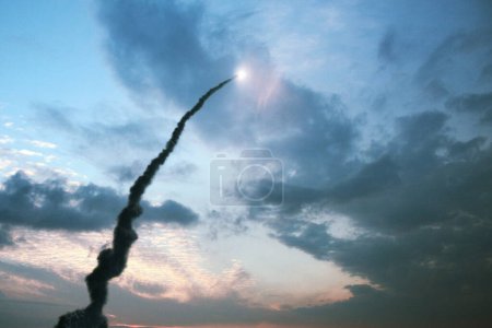 Successful launch of a rocket with a smoke trail into the sky with clouds. Space Shuttle ship take off through the clouds into space
