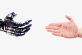 Robot hand reaches out to the human hand. Handshake of a cyborg and a man. Technology concept. Friendship between a robot and a human tote bag #645246472