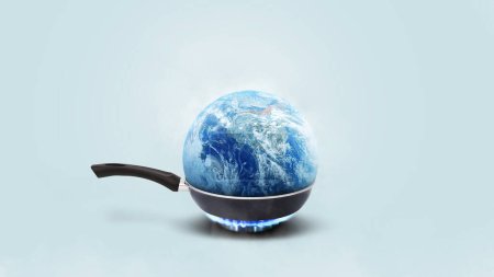 Der Planet Erde brennt in einer Pfanne auf einem Gasbrenner auf blauem Hintergrund, Konzept. Globale Erwärmung und Klimawandel, kreative Idee. Rettet den Planeten Erde