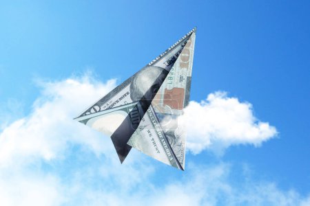 Paper airplane 100 dollars flies into the sky with clouds, creative idea. Startup and investment finance, concept. Insurance and deposits