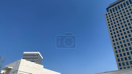 a building landscape with a blue sky and a white building blank copy for space