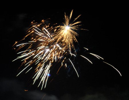 Photo for A fascinating view of fire crackers bursting in the sky with dazzling look mesmerizing during Diwali festival at Namchi in Sikkim, India. It was banned in Sikkim due to noise and air pollution in 2008 which was silently the this year. - Royalty Free Image