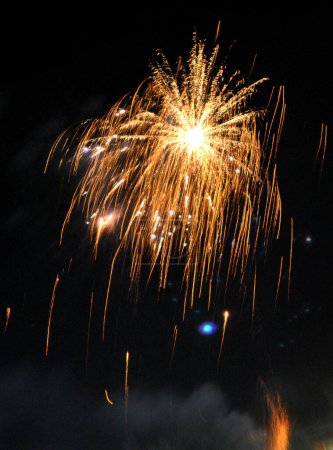 Photo for A fascinating view of fire crackers bursting in the sky with dazzling look mesmerizing during Diwali festival at Namchi in Sikkim, India. Its is banned in Sikkim due to noise and air pollution in 2008 which was silently lifted the banned this year. - Royalty Free Image