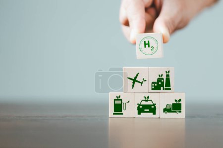 Photo for Free Carbon, alternative energy and global climate change concepts. Hand flipping wooden cube blocks with CO2 Carbon dioxide, change to H2 Hydrogen text on table background. Sustainable car energy. - Royalty Free Image
